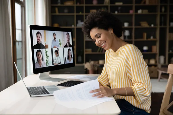 Focused smiling young African American woman holding video call. — Foto de Stock