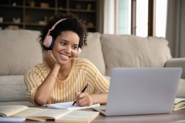 Happy young attractive African American woman studying distantly.