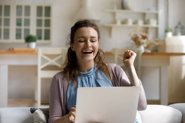 Cheerful laughing young woman celebrating internet success. — ストック写真