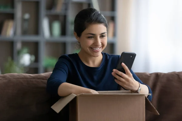 Happy beautiful young Indian woman satisfied with online shopping. — Zdjęcie stockowe