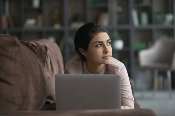 Dreamy happy young Indian woman using computer. — Zdjęcie stockowe