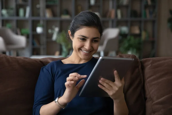 Happy young Indian ethnicity woman using digital computer tablet. — Stockfoto