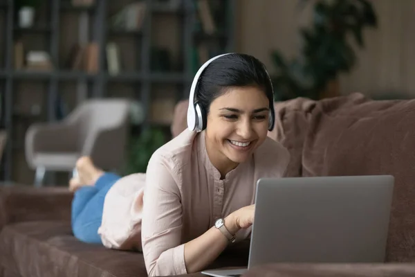 Happy attractive millennial Indian woman holding video call.