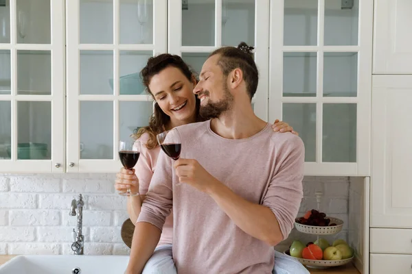 Happy family couple clinking glasses, dating at home. — Photo