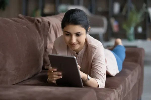 Cheerful young Indian woman using digital computer tablet. — Stock Photo, Image