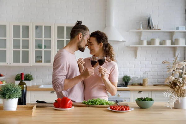 Happy young Caucasian family couple enjoying romantic moment in kitchen. — Stockfoto