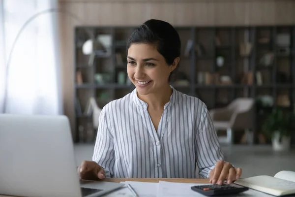 Happy young Indian woman managing monthly budget. — стокове фото