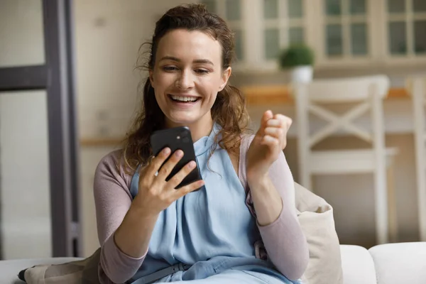 Happy laughing young woman celebrating internet success. — Foto Stock