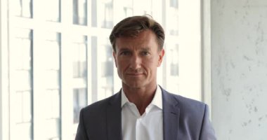 Head shot portrait middle-aged businessman pose in modern office