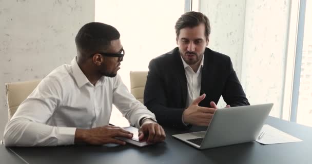 Multiethnic businessmen working on collaborative project at workplace — Stockvideo