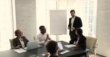 Boss holds briefing with multi ethnic company employees