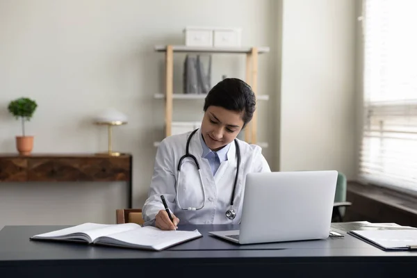 Happy millennial Indian doctor working in modern office. — Stock Photo, Image