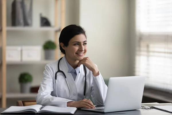 Happy motivated young Indian doctor enjoying break time. — Stok fotoğraf