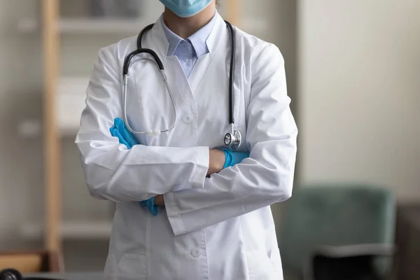 Cropped image young female doctor standing with folded arms. — Stockfoto