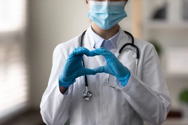 Close up young Indian doctor making heart sign. — Stock Photo, Image