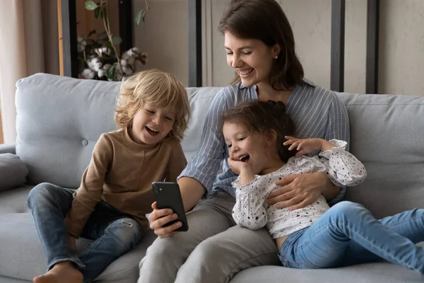 행복 한 어린 아이들 과 핸드폰을 사용하는 자상 한 엄마들. — 스톡 사진