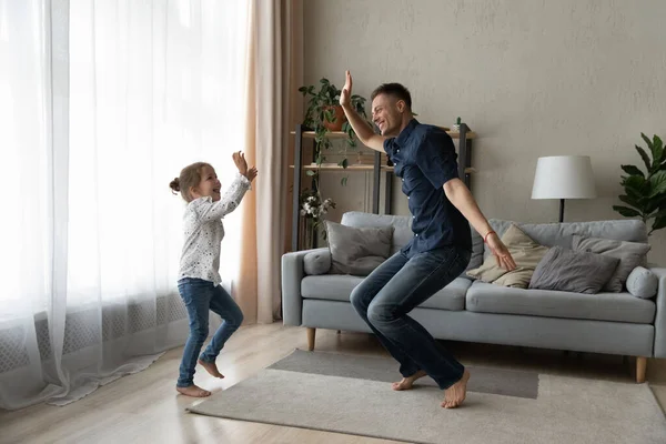 Rindo alegre criança pequena dançando com pai alegre. — Fotografia de Stock