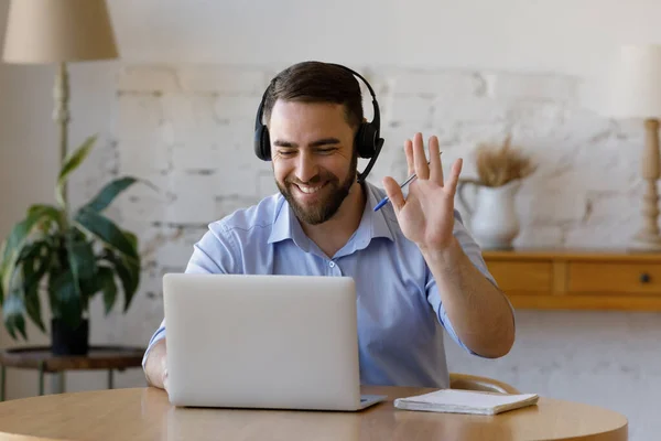 Happy friendly support employee in headphones talking on video call — Stock Photo, Image