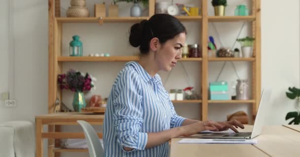 Businesswoman use laptop do freelance work looks focused — Stock video