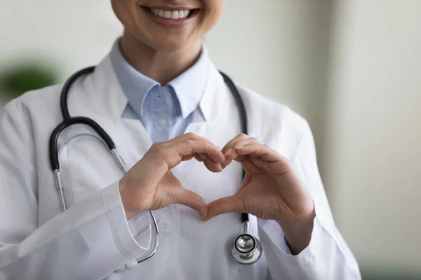 Close up happy young Indian doctor making heart gesture. — Stock Photo, Image