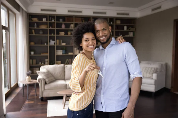 Feliz pareja africana mostrando las llaves de su nueva casa —  Fotos de Stock