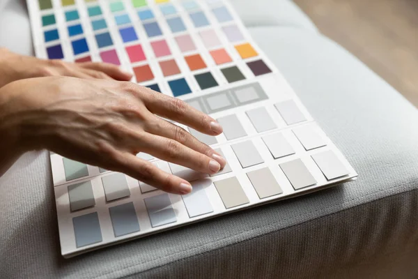 Female hands on paint swatches palette close up — Stock Photo, Image