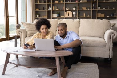 Ciddi Afrikalı çiftler internet faturalarını ödüyor, ev giderlerini hesaplıyorlar.
