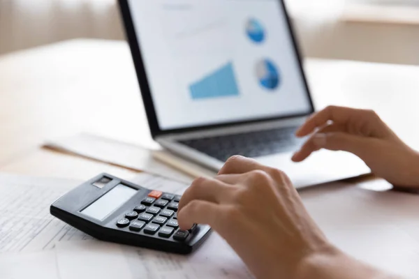 Analyst woman sit at table use laptop and calculator closeup — Stock Photo, Image