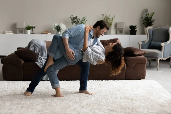 Loving husband dancing tango with lovely wife in living room — Stock Photo, Image