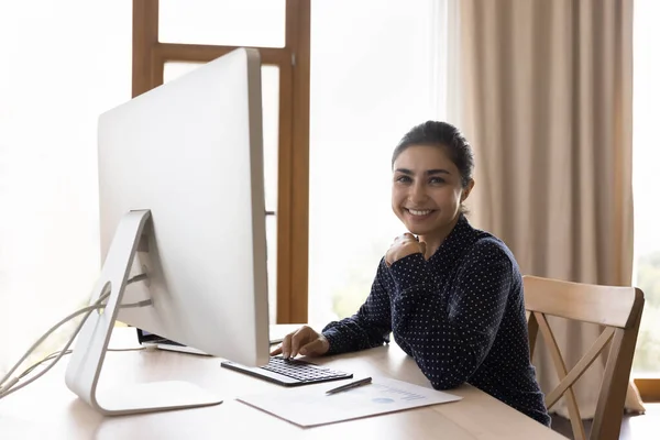 Portrait of smiling millennial Indian businesswoman working in office. — Stock Photo, Image