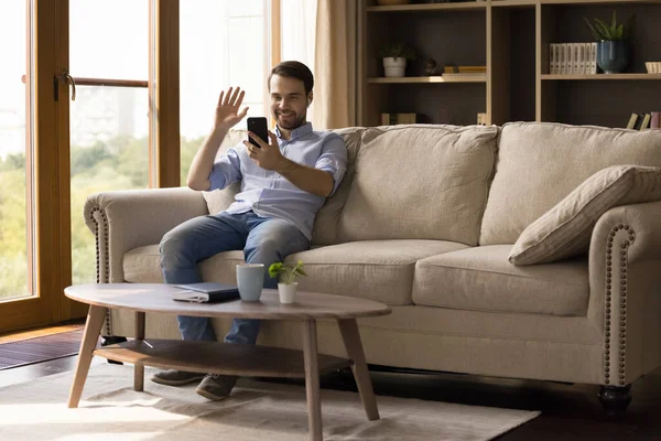 Glücklicher Millennial-Mann mit Kopfhörer hält Videoanruf. — Stockfoto