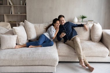 Mutlu kadın ve erkek sarılıyor, akıllı telefon kullanıyor.