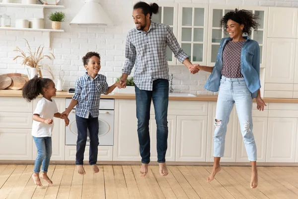 Happy millennial African American family dancing in modern kitchen. — Stock Photo, Image
