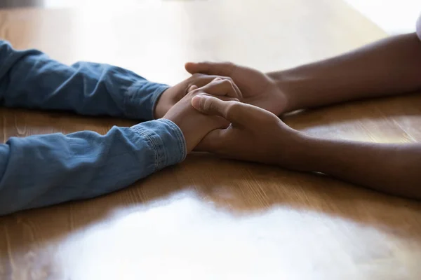 Young Black couple holding arms over table, having difficult conversation — Stock Photo, Image