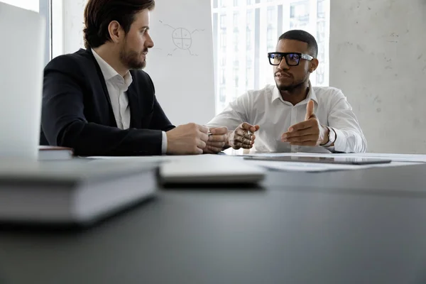 Diverse business partners discussing project at meeting table — Stock Photo, Image