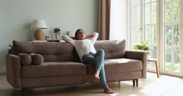 Peaceful Indian woman relaxing in living room leaned on sofa — Stock Video