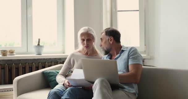 Older couple reviewing expenses feeling stressed due lack of money — Stock Video