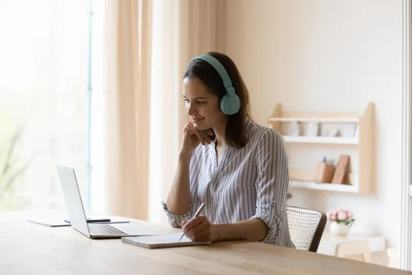 Focused happy millennial woman e-learning at home office. — Stock Photo, Image