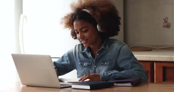 African teenage girl studying remotely use laptop and videocall app — Stock Video