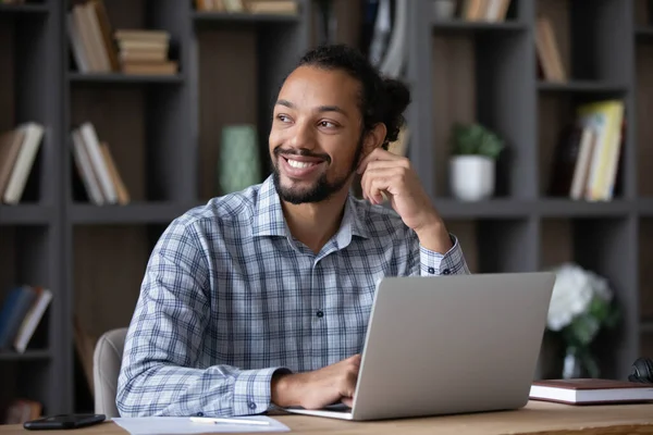 Distraído do trabalho laptop sorrindo homem africano olhando à distância. — Fotografia de Stock