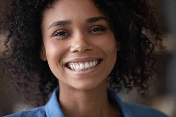 Glückliche junge Afroamerikanerin zeigt perfektes Lächeln. — Stockfoto