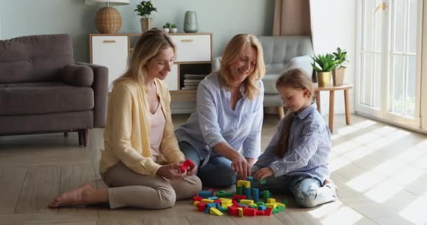 Friendly multigeneration family play cubes sit on floor at home — стоковое видео