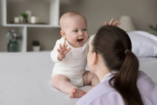 Happy excited baby laughing at mom face, showing positive emotions — Stock Photo, Image