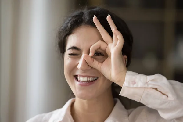 Close up happy young Hispanic woman making binocular sign. — Stock Photo, Image