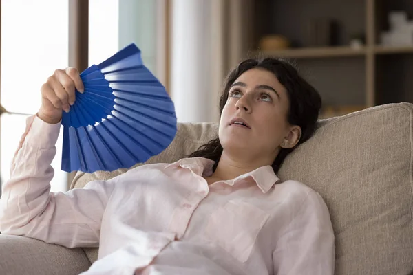 Exhausted unhappy young Hispanic woman feeling overheated. — Stock Photo, Image