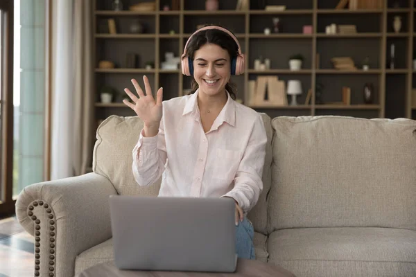 Happy pretty young Hispanic woman in headphones starting video call. — Stock Photo, Image