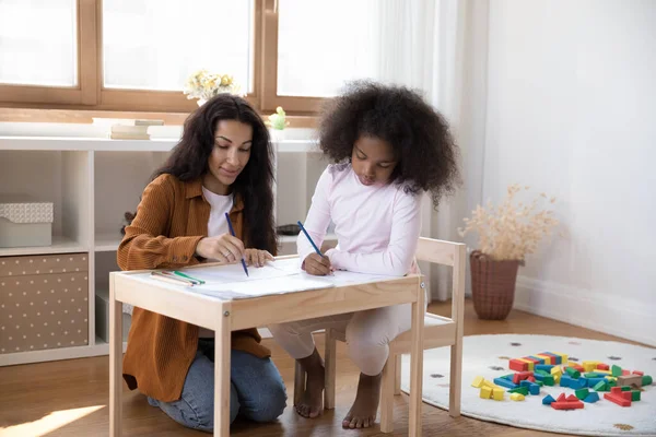 Feliz joven afroamericano madre dibujo con hija. —  Fotos de Stock