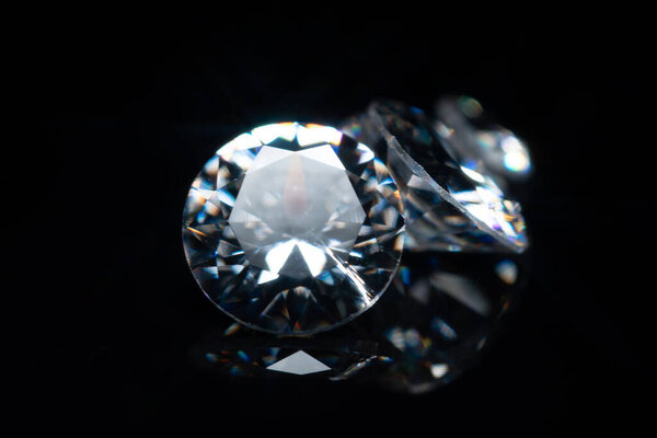 Shiny diamond stones collection selective focus, isolated on black. Luxury gem brilliants. Display and inspections of polish quality and contamination. Carbon material.