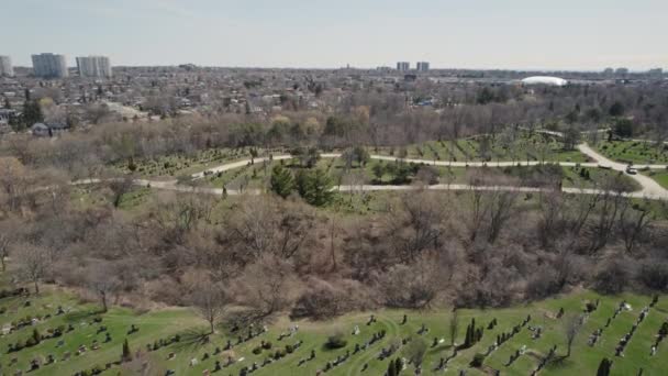 Aerial top very high view of modern cemetery at the city. Small headstones and crosses at graveyard with gravestones. — Stockvideo