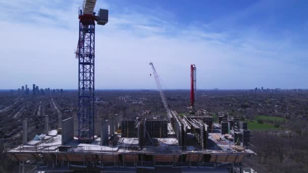 Aerial flight near and around new constructions building development site. Modern architecture of skyscrapers and high rise housing. Real Estate concept. Empty working area, cranes and heavy machinery — Stockvideo